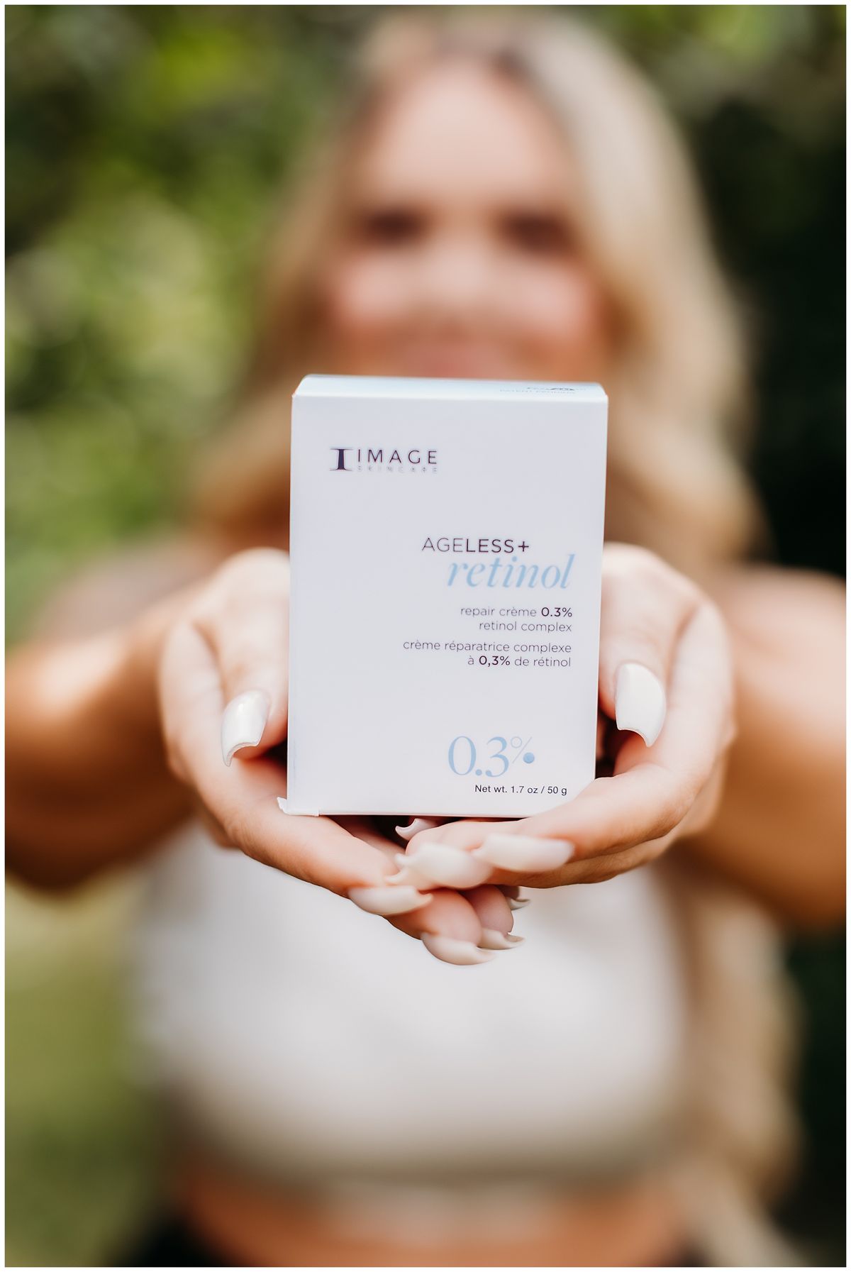 Hands holding a retinol product box